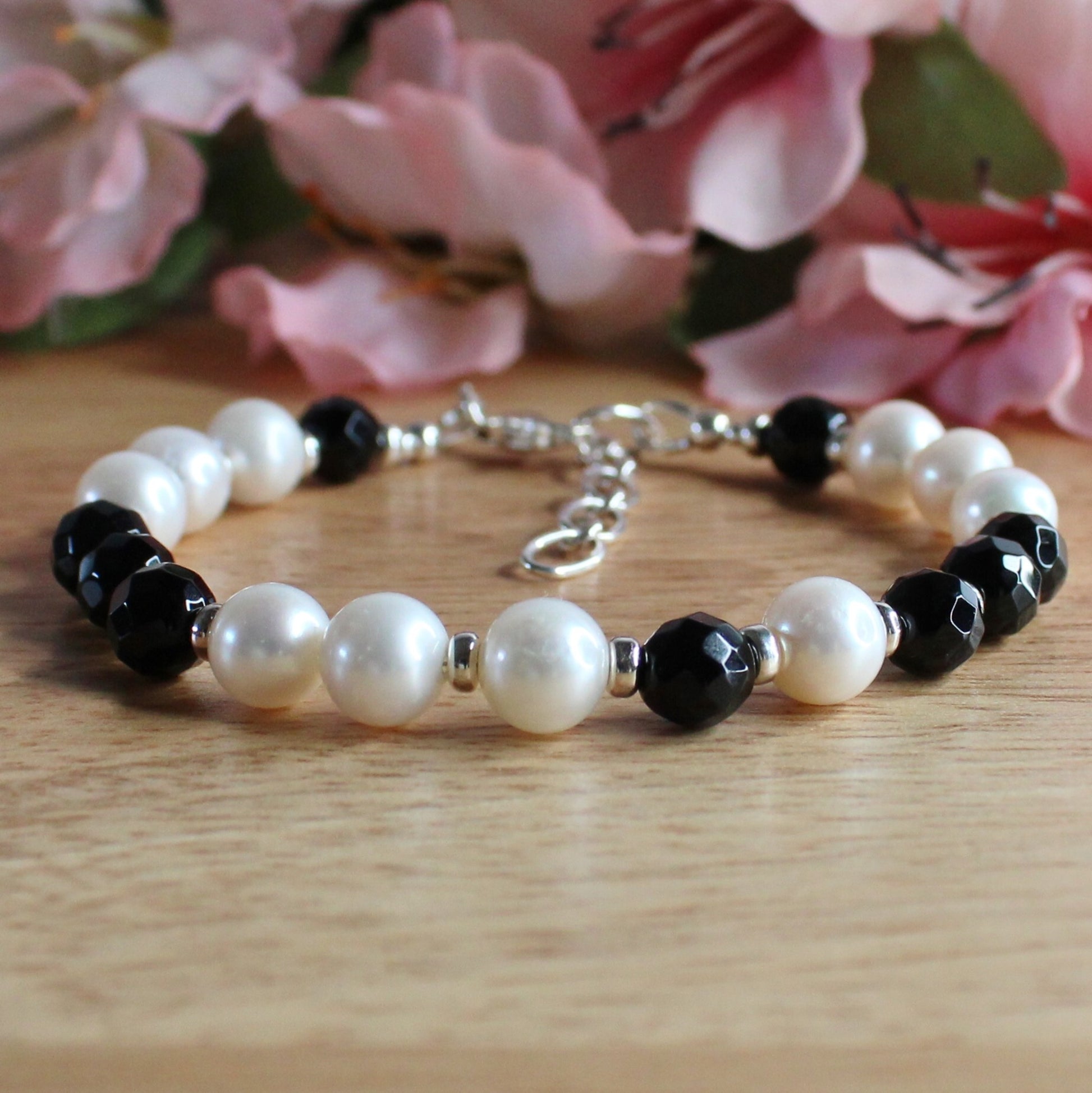 handcrafted black onyx & pearl bracelet. Facetted black onyx beads, white round freshwater pearls, sterling silver accent beads, lobster clasp and extender chain