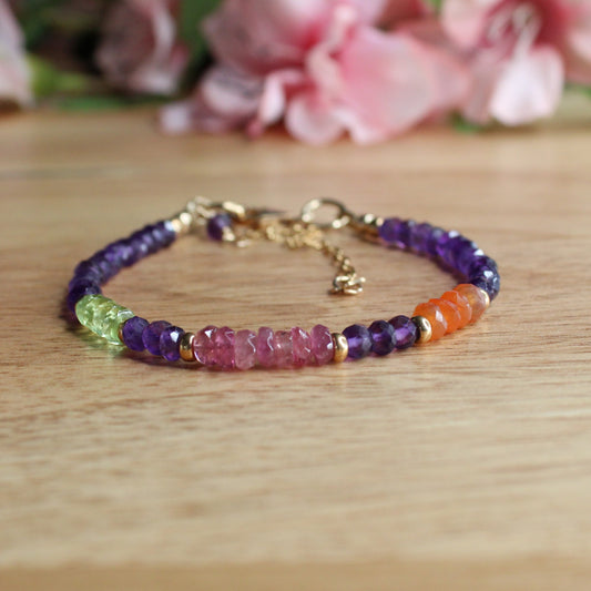 handcrafted mixed gemstone bracelet. genuine amethyst, pink tourmaline, peridot, carnelian facetted gemstone beads. 14k yellow gold filled accent beads, lobster clasp, extender chain.