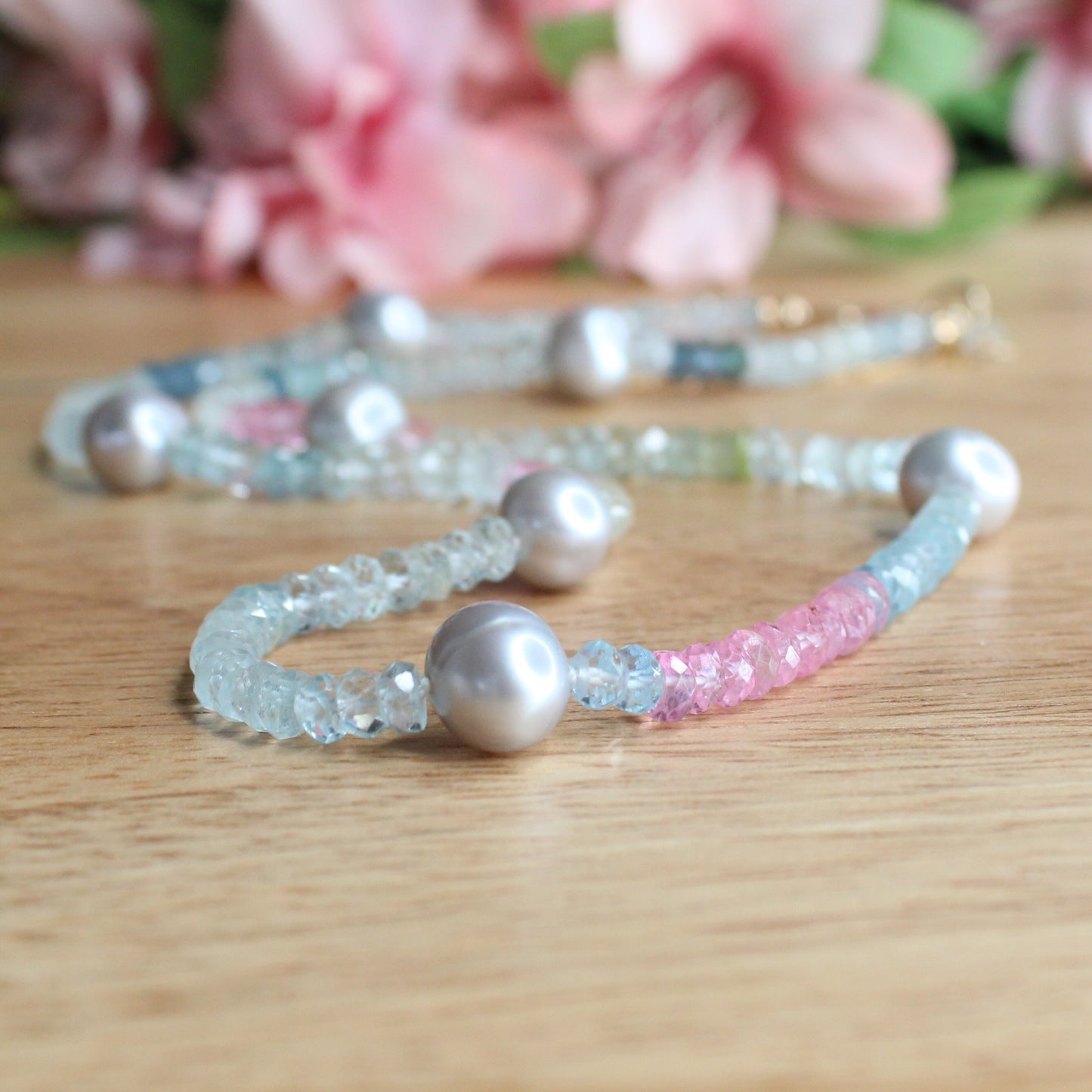 aquamarine and pearl necklace. grey oval freshwater pearls. shaded aquamarine facetted gemstone beads. facetted rondelle pink morganite. gold filled lobster clasp.