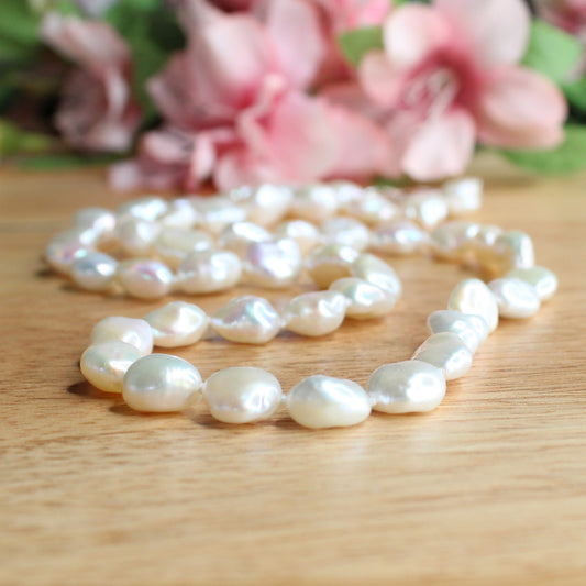 white baroque freshwater pearl necklace hand knotted on silk. sterling silver lobster clasp