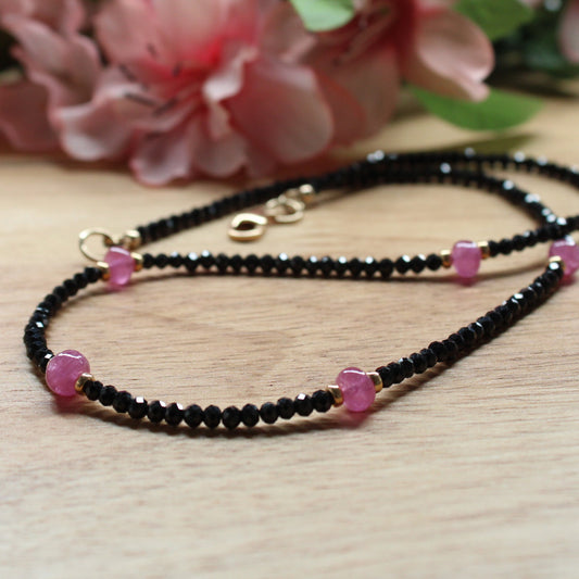 Black spinel and pink sapphire necklace. hand crafted. facetted rondelle black spinel. smooth pink sapphire rondelle beads. sterling silver accent beads and lobster clasp.